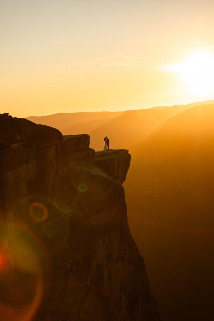 Couple eloping at Taft Point during sunset, the best time to elope in Yosemite